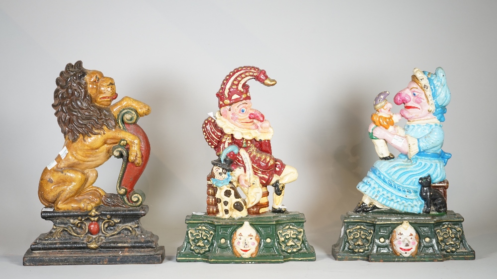 A group of three 20th century painted cast iron door stops, Punch & Judy and a lion, each 35cm high,