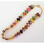 A gold and varicoloured gemstone bracelet,