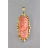 A gold mounted coral pendant, as converted from a clasp,