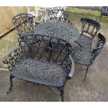 A 20th century black painted cast iron small garden bench,