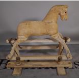 An early 20th century pine rocking horse, 80cm wide x 84cm high, (a.f.).