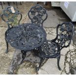 A set of three 20th century black painted cast iron garden chairs with rose decorated back and two