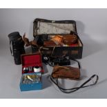 A quantity of early 20th century vintage cameras and accessories, within a leather suitcase,