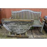 Garden furniture; a teak arched back garden bench,