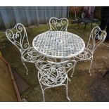 A set of four 20th century white painted metal garden armchairs with heart shaped backs and