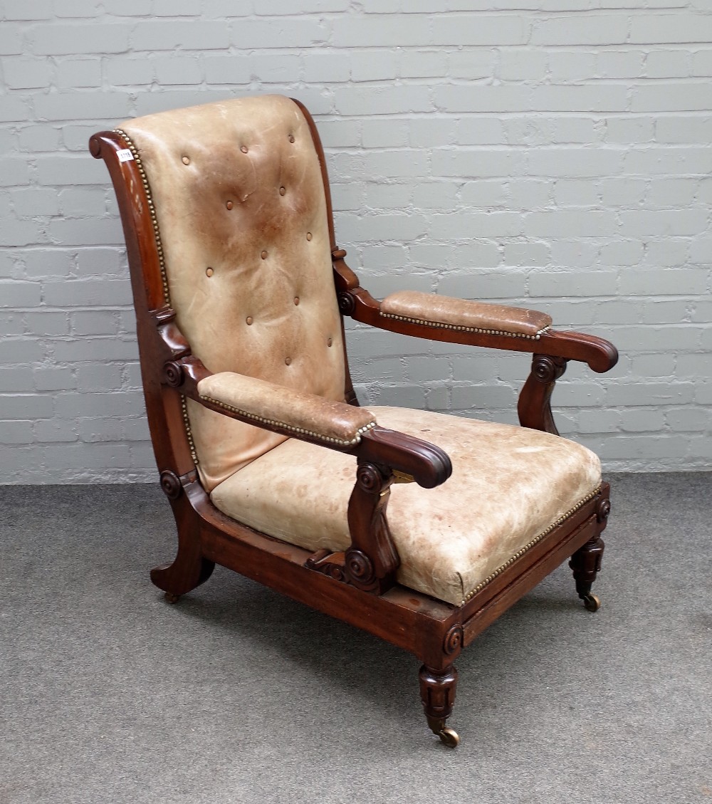 A William IV mahogany leather upholstered open arm easy chair with adjustable back and integral