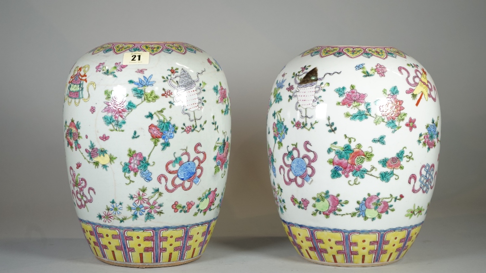 A pair of early 20th century Chinese vases, (lacking covers), decorated with Buddhist symbols,