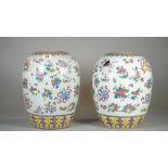 A pair of early 20th century Chinese vases, (lacking covers), decorated with Buddhist symbols,