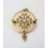 A gold, aquamarine and seed pearl set pendant brooch, in a circular openwork design,