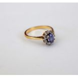 An 18ct gold, sapphire and diamond oval cluster ring,