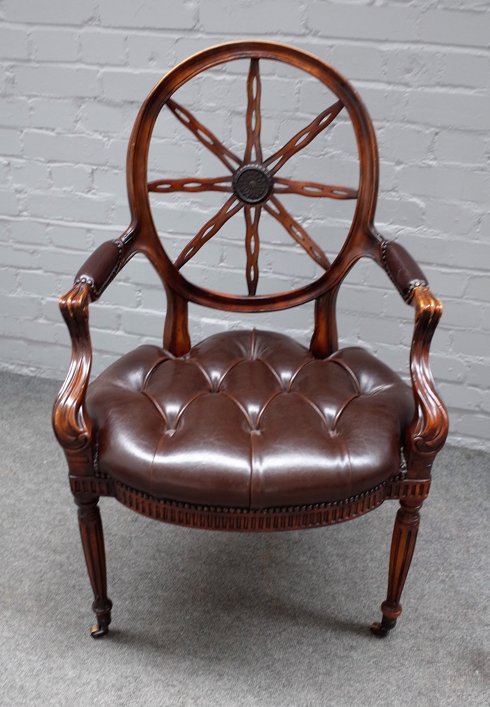 An 18th century style spiderweb back office chair, on fluted supports, 65cm wide x 100cm high.