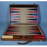 A 20th century brown leather cased travelling Backgammon set, 67cm wide.