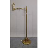 A 20th century brass adjustable standard lamp on circular plinth base, 107cm high.