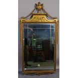 An 18th century style gilt framed wall mirror, with urn and swag surmount, 56cm wide x 114cm high.