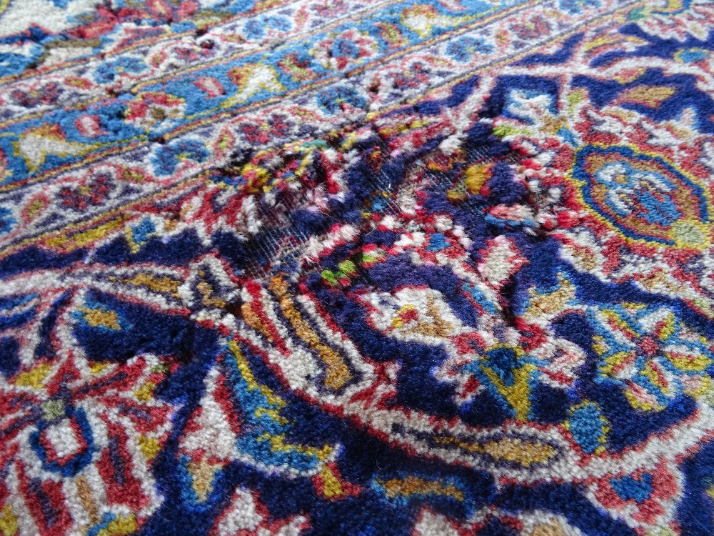 A Kashan carpet, Persian, the madder field with a bold indigo medallion, matching spandrels, - Image 7 of 7