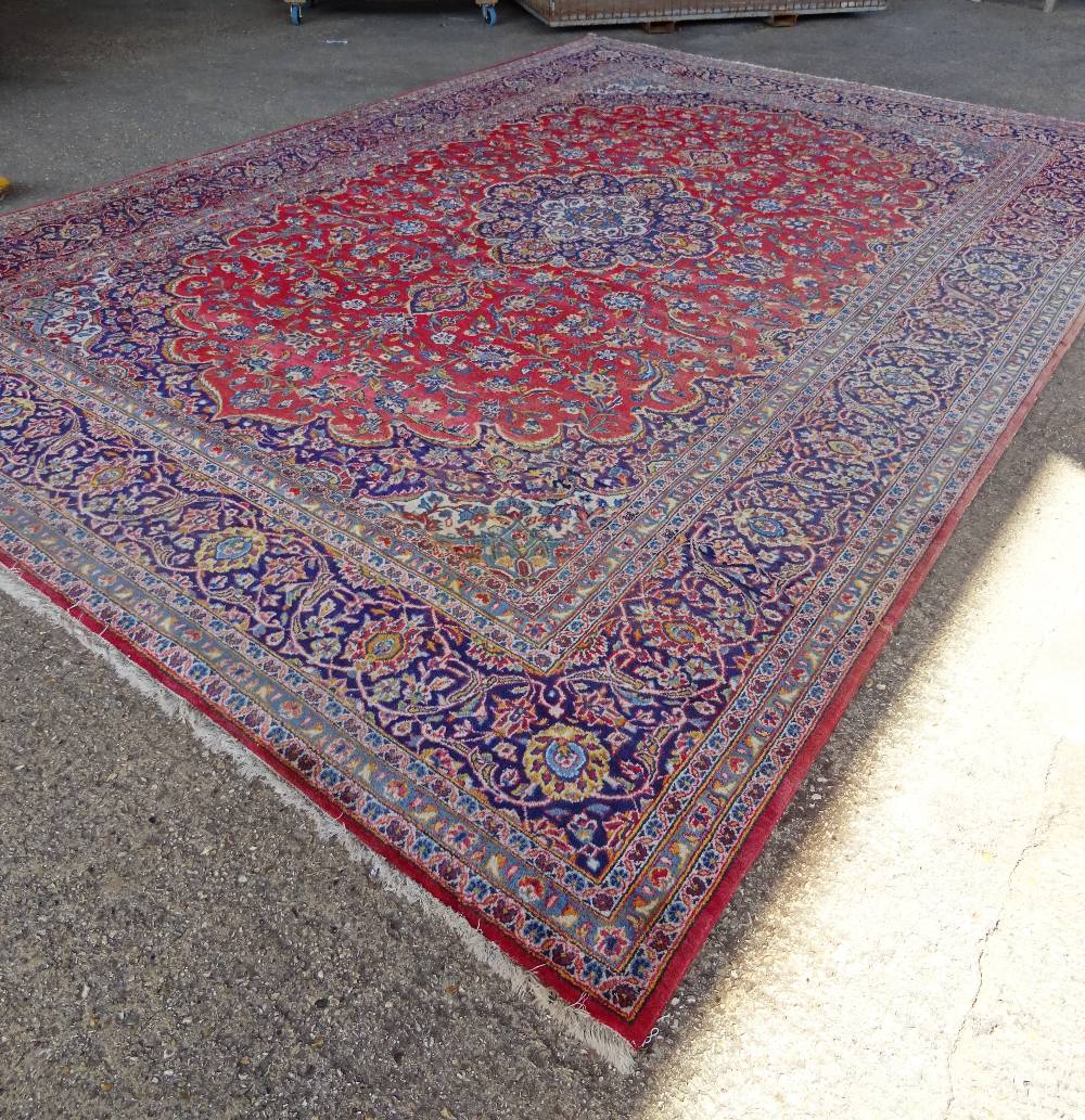 A Kashan carpet, Persian, the madder field with a bold indigo medallion, matching spandrels, - Image 2 of 7