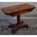 A 19th century rosewood rectangular foldover tea table, with turned column and quatrefoil base,