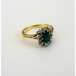 An 18ct gold, emerald and diamond cluster ring,