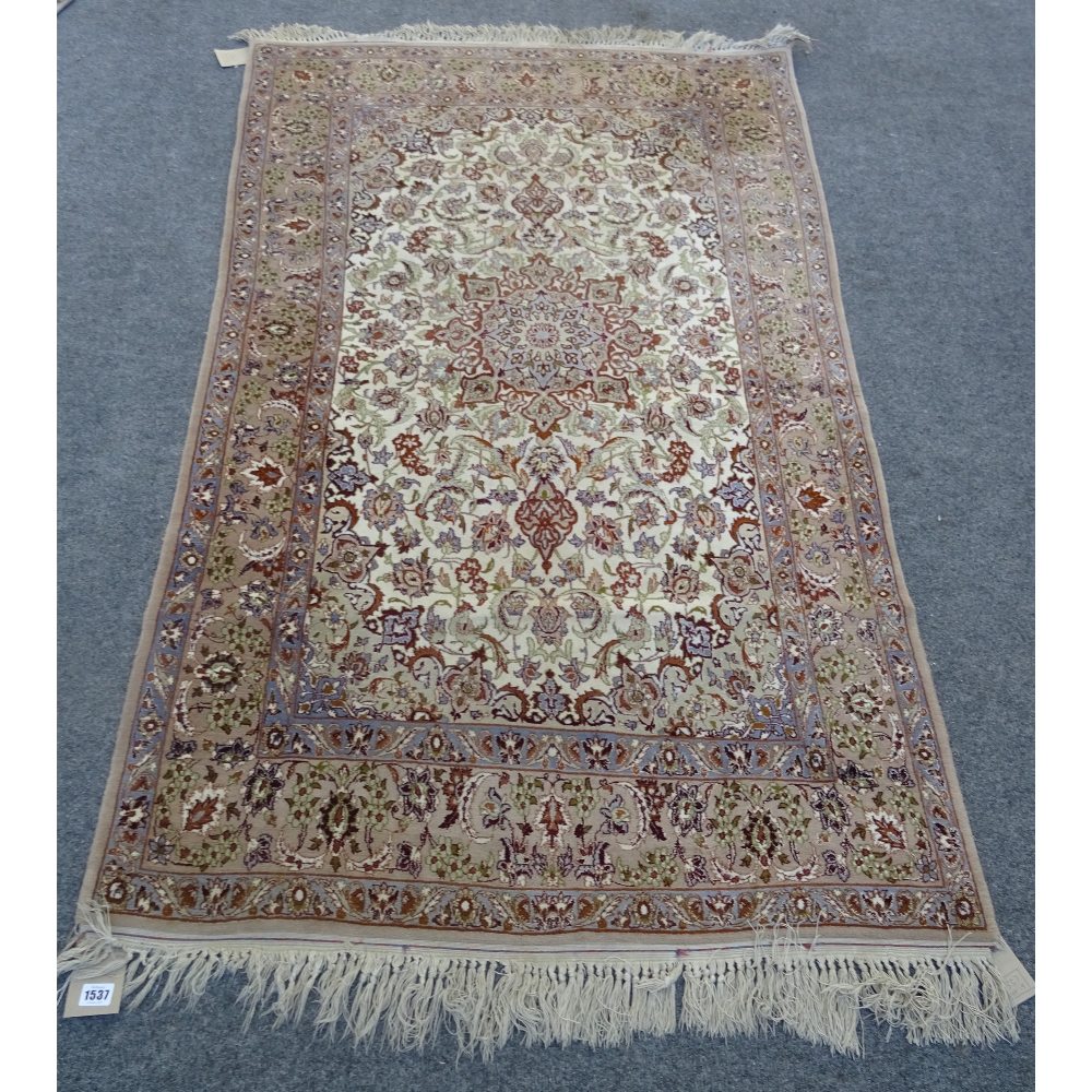 A fine part silk Esfahan rug, Persian, the ivory field with a brown shaped medallion,