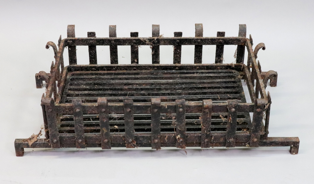 A large rectangular cast iron fire baske