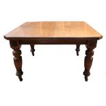 A late Victorian light oak extending dining table,