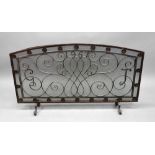 A large arched top rectangular wrought iron and mesh fireguard, 128cm wide x 72cm high.
