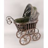 A doll's pram, on four spoked wheels wit