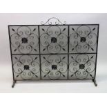 A large rectangular wrought iron and mesh fire guard, 115cm wide x 90cm high.