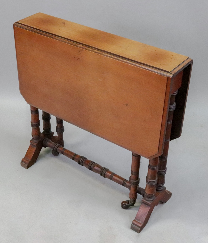 An Edwardian walnut sutherland table, on