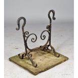 A Victorian wrought iron boot scraper of scroll work form,