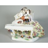 A Meissen group of lovers, late 19th century, modelled as a seated young woman playing the spinnet,