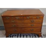 A late George III mahogany low chest of two short and three long graduated drawers on bracket feet
