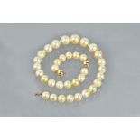 A cultured pearl single row necklace and earring suite, of slightly graduated design,