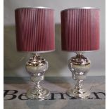 A pair of 20th century silvered glass table lamps of baluster form, with red mesh shades, 85cm high,