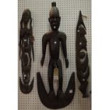 Tribal interest; Three Sepik river carved wooden food hooks, the largest 92cm.