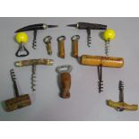 Four late 19th century direct pull corkscrews, each with horn handle,