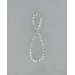 A white precious metal and diamond set pendant of figure of eight design,