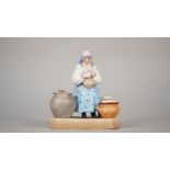 A Russian biscuit porcelain figure of a women on a bench, Gardner factory, late 19th century,