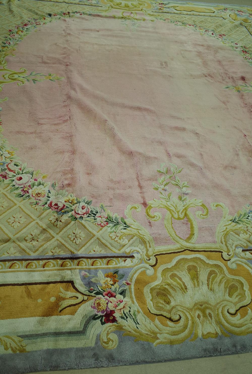 A Savonnerie carpet, French, the plain pale pink field with trellis spandrels and floral garlands, - Image 6 of 16