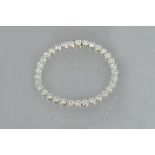 An 18ct white gold and diamond set tennis bracelet,