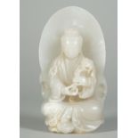 A Chinese white jade figure of Guanyin, Qing dynasty, the goddess seated before an oval mandorla,