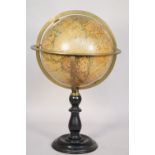 A French nine inch 'Ikelmer' world globe on a turned ebonised wooden stand, 48cm high.