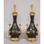 A pair of French bronze and ormolu mounted table lamps, each of two handled vase form,