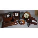 Horological interest, comprising; a group of five 20th century wall mounted clocks and a bracket,