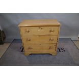 A late Victorian pine chest of three long drawers on bracket feet.
