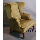 A Queen Anne style mahogany framed wingback armchair, on tapering pad feet, 80cm wide x 107cm high.