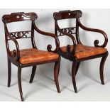 A pair of Regency mahogany carver chairs with parcel gilt floral motif crest over pierced waist