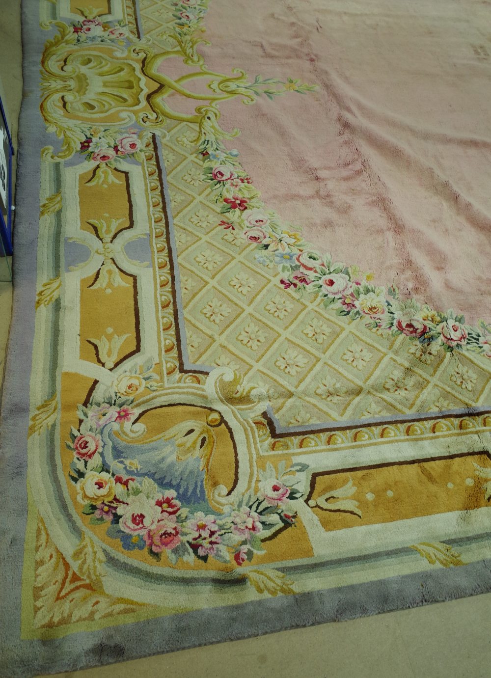 A Savonnerie carpet, French, the plain pale pink field with trellis spandrels and floral garlands, - Image 5 of 16