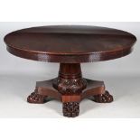 A modern mahogany extending 'Jupe style' dining table, the circular top 150cm diameter,