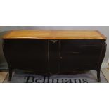 A 20th century French black painted sideboard of bombe form, 180cm wide x 90cm high.